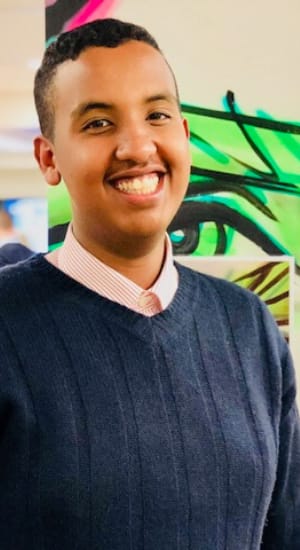 Mohamoud smiling, from ear to ear, reflecting on his success